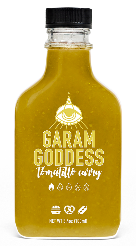 Garam Goddess Tomatillo Curry hot sauce bottle with label highlighting its vegan and gluten-free ingredients like curry leaves and cumin